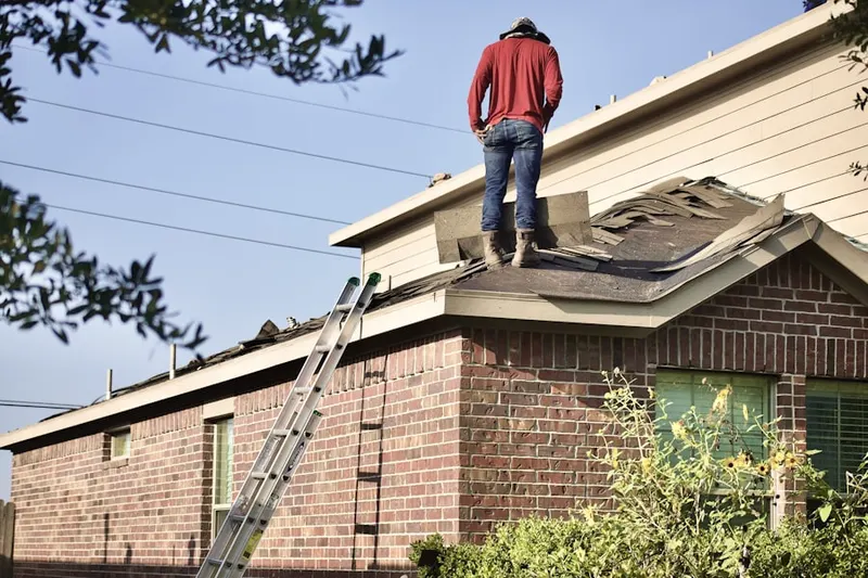 Professional roofer working on a residential roof in Augusta Village